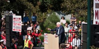 Dems Post SICKENING Trump Meme During 250th Celebrations speaker at outdoor rally addressing a large crowd
