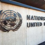 Facade of the United Nations building featuring the UN emblem and text