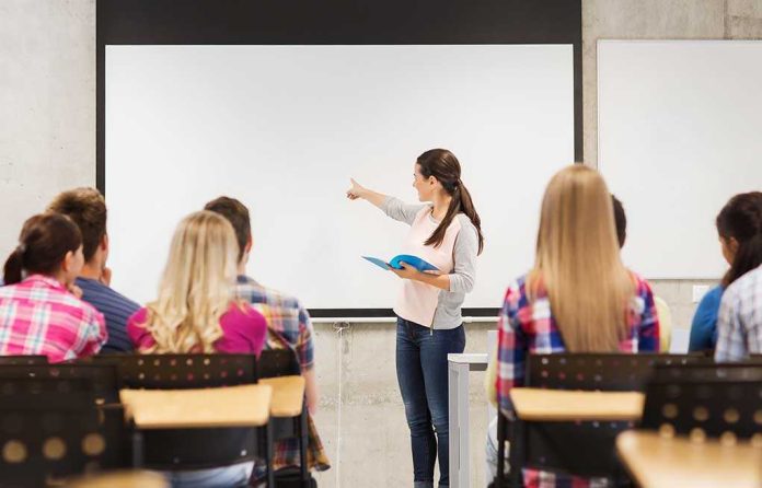 shutterstock_220706344 A teacher presenting to students in a classroom