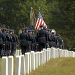 84 Years Later, WW2 Soldier Comes Home Military honor guard marches through a cemetery with flags