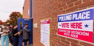 Voting Station LOCKED DOWN Day of Election Voters line up outside a brick building polling place