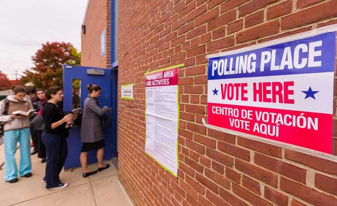 shutterstock_1047600703 Voters line up outside a brick building polling place