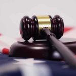 Judge’s gavel on a base over an American flag