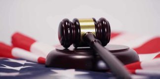 Judge’s gavel on a base over an American flag