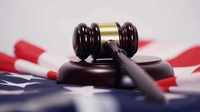 Judge’s gavel on a base over an American flag