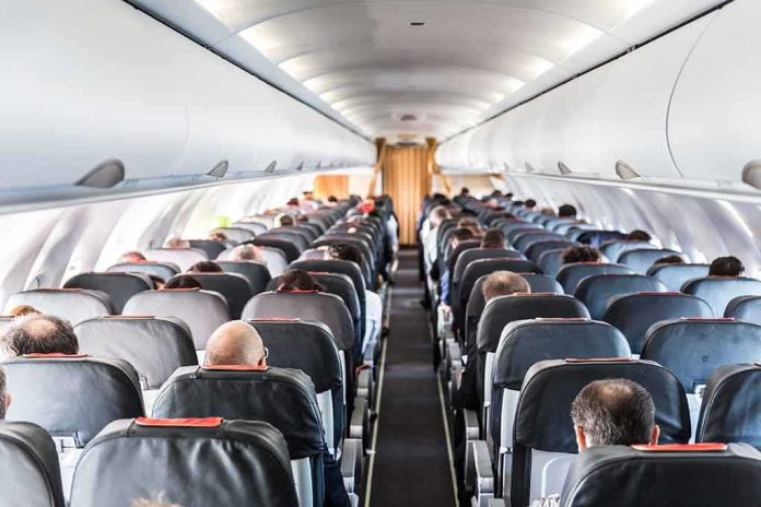 Airplane cabin with passengers seated in rows