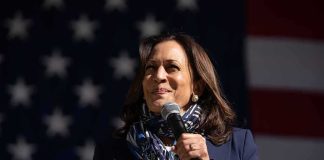 Kamala Commits Embarrassing Blunder as She Launches Radical 2028 Plan Woman speaking into a microphone on a stage