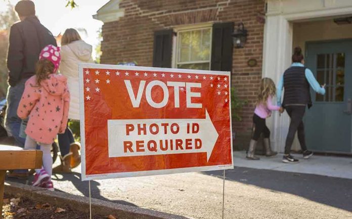 Red voting sign with arrow near people entering a polling place