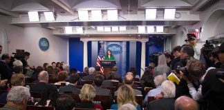 Press secretary speaks at White House briefing room podium
