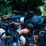 Child Left With Half a Skull After Illegal Trucker Accident! TV news cameras crowding together at an outdoor event