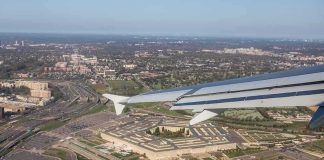 airplane wing over a sprawling government complex