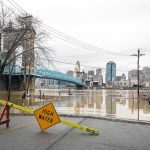 5 DROWNED In Summer Camp Disaster Flooded riverfront with bridge and city skyline