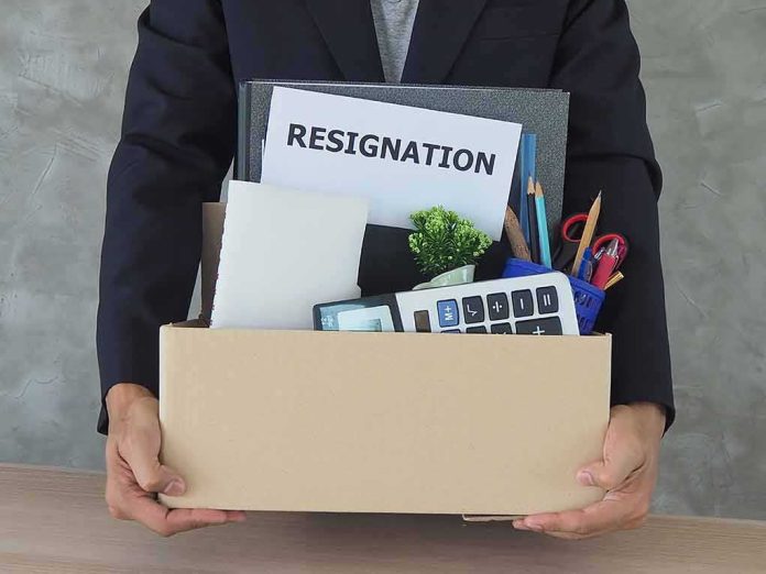 Person holding a cardboard box of office belongings