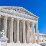 Supreme Court Greenlights Voter Check Tool Supreme Court building with tall marble columns under a clear blue sky
