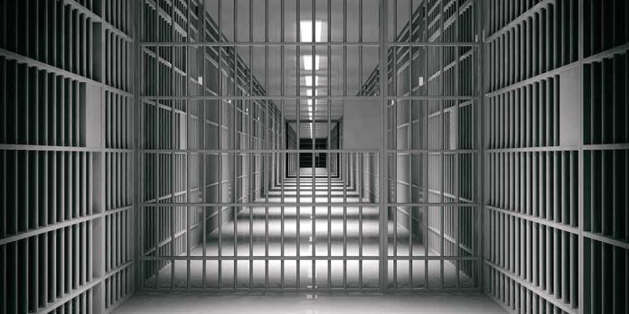 shutterstock_1118920109-1 empty prison corridor with barred cells