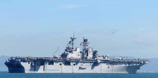 Aircraft carrier sailing on calm blue water