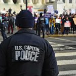 Police officer monitoring a protest on a city street