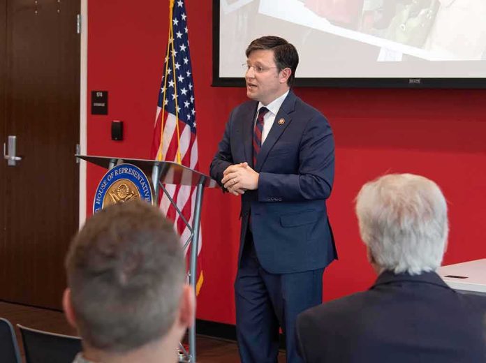 shutterstock_1381036310-1 Speaker in a navy suit addressing an audience at a podium