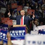 Donald Trump speaks at a rally, giving two thumbs up
