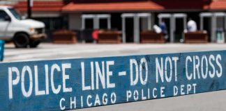 Police barricade with 'Do Not Cross' message in urban street