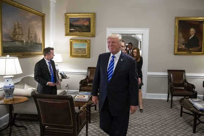 shutterstock_1456093772 Donald Trump walks through an office with Sean Lawler nearby and Mariano Rajoy following behind