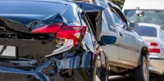 Damaged black car after rear-end collision