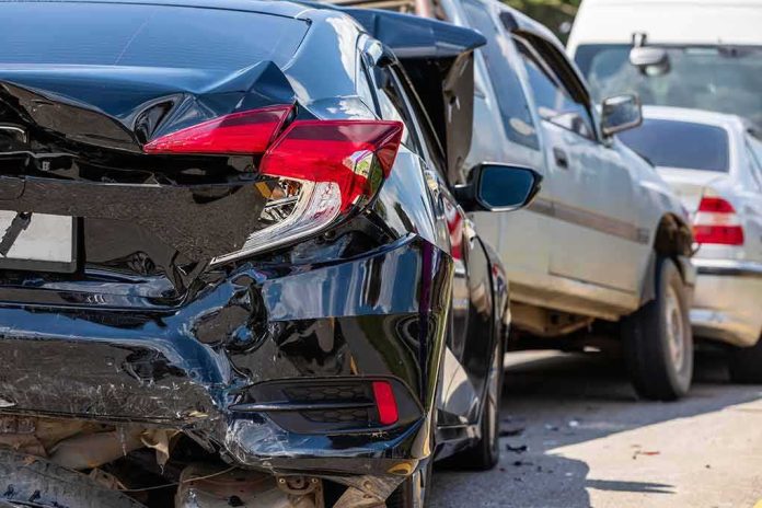 Damaged black car after rear-end collision