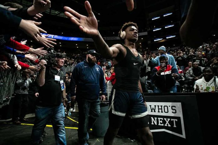 shutterstock_1593580081 Basketball player in arena high-fives fans while wearing headphones