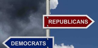 Directional signs for two political parties on a pole
