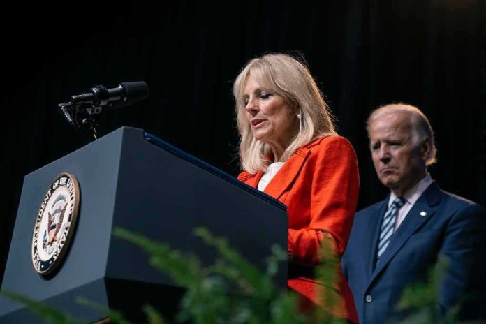 Jill Biden speaks at a podium as Joe Biden stands behind her