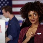 Muslim Dem Candidate Now Claims He’s African Voter showing an I Voted sticker at a polling place
