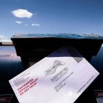 Ballots Dumped In Church Dumpster Mail-in ballot being inserted into a blue USPS mailbox