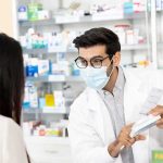 Pharmacies RUN OUT Of Crucial Drugs Across Country! Pharmacist wearing mask explains medication to customer