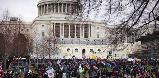 Crowd gathered outside a large domed government building