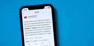 smartphone displaying a social media thread on a blue background
