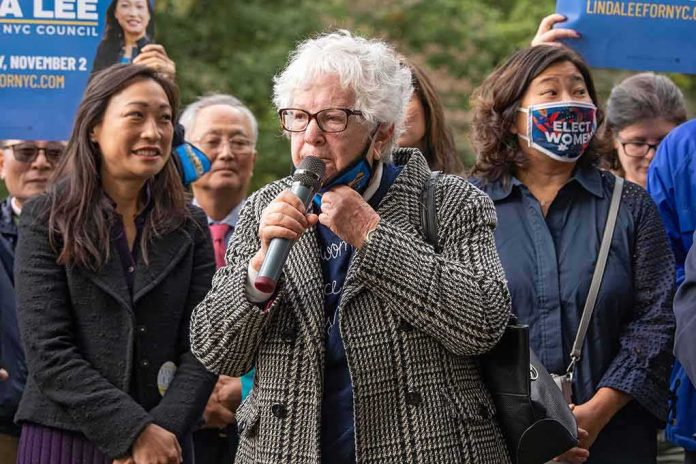 Như Quỳnh and Grace Meng at an outdoor rally with a speaker holding a microphone
