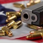 Wanna Trump Assassin’s Courtroom Stunts Infuriates! Handgun with bullets on an American flag
