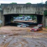 State of Emergency – Flash Flood Emergency Slams Region Flooded underpass with stranded cars in muddy water