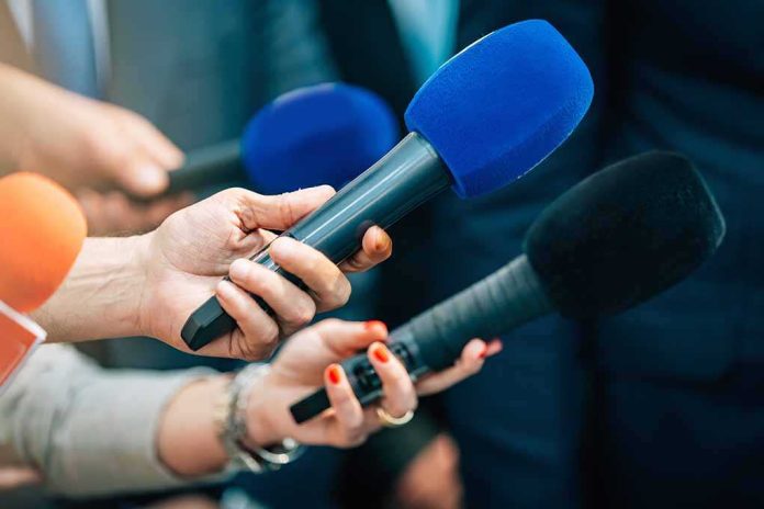 shutterstock_2168392339 Reporters holding colorful microphones