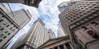 Skyscrapers and a neoclassical building with columns viewed from street level