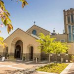 After 156-Years Beloved Church Razed To The Ground Brick church with arched entrance and tall bell tower on a sunny day