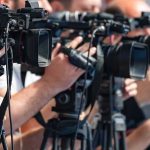 DEADLY Explosion Rocks Shipyard! television cameras on tripods at a media event
