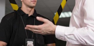 Police officer taking notes during a conversation
