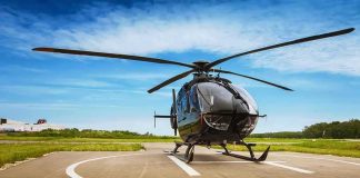 Black helicopter on a helipad