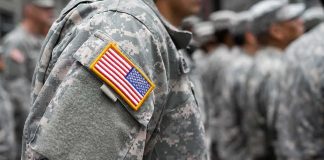 Soldier in camouflage uniform with U.S. flag patch