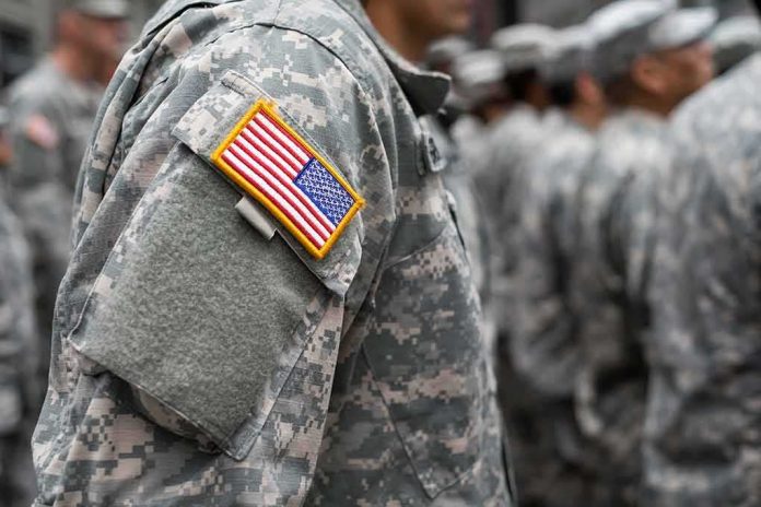 Soldier in camouflage uniform with U.S. flag patch
