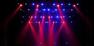 stage with red and blue spotlights shining onto an empty floor