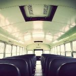 Empty school bus interior with rows of seats