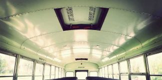 Empty school bus interior with rows of seats