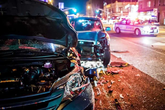 Wrecked cars at night crash scene with police lights